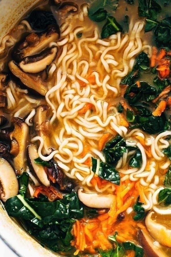 Home made ramen noodles with rich broth, mushrooms, greens, sliced red papper