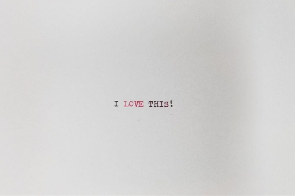 Typed index card that reads I LOVE THIS! The word LOVE is typed in red.