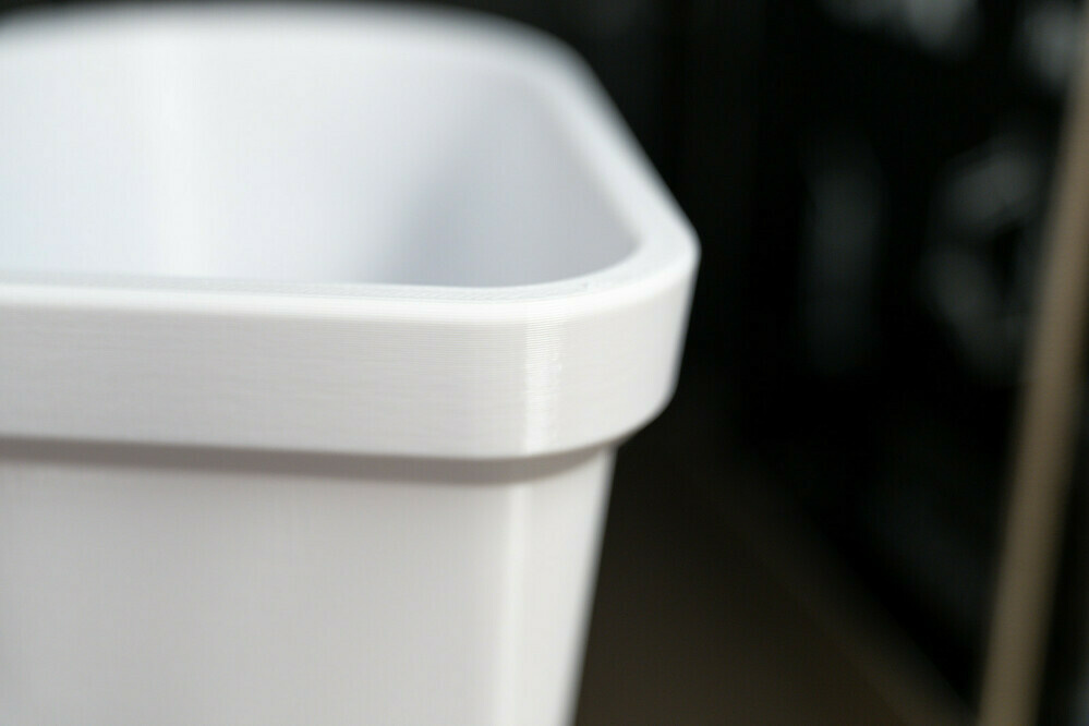 Photo of a 3D printed flower pot in a heart shape. Detail of the rim, showing of the smooth geometry.