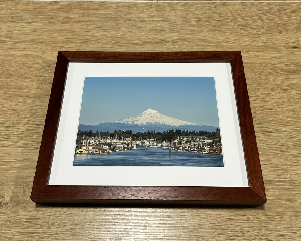 A framed photograph of North Portland Harbor with Mount Hood in the background. A plane is seen departing from the airport.