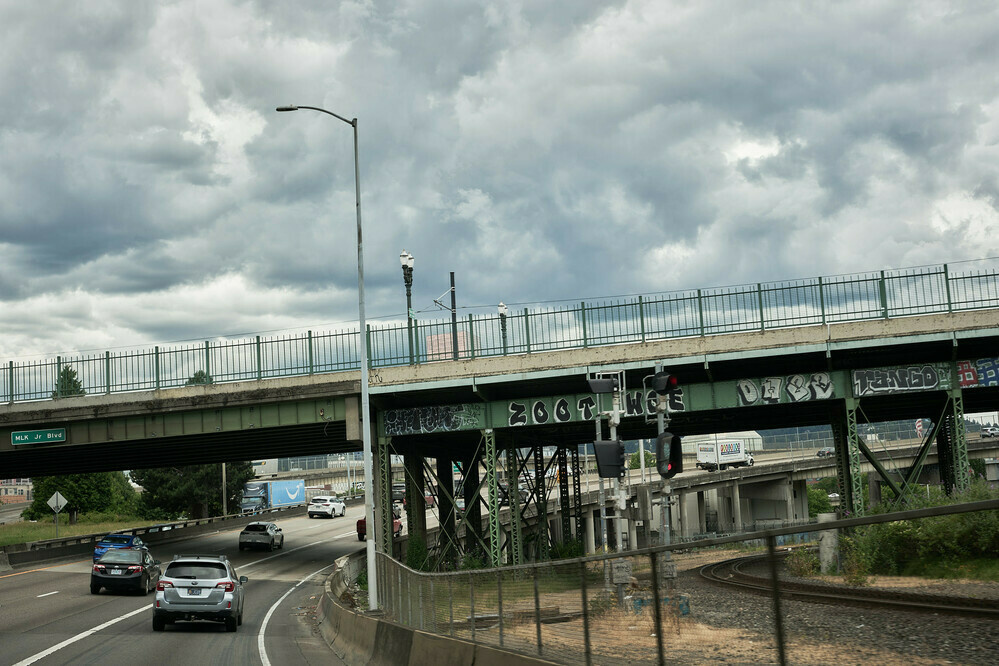 Clouds over Interstate 84 and the railroad trucks.