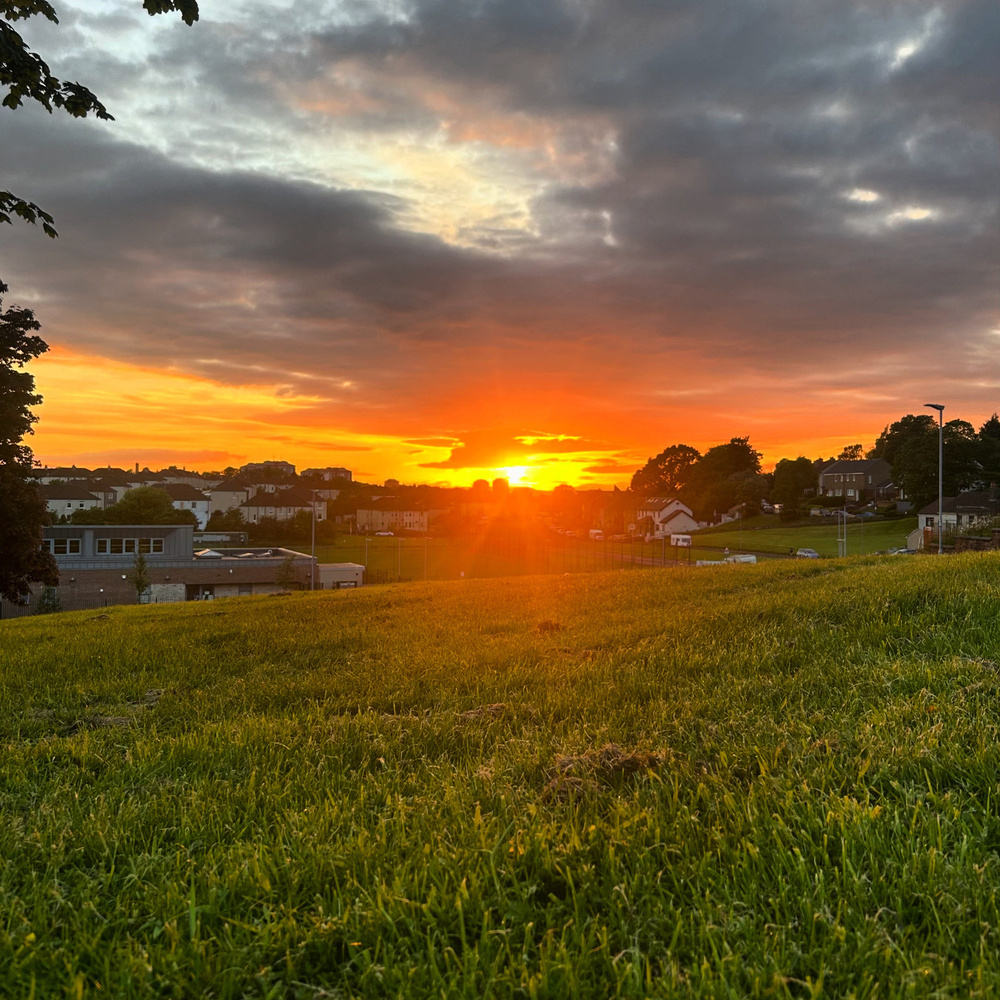 A sunset viewed from a hill.