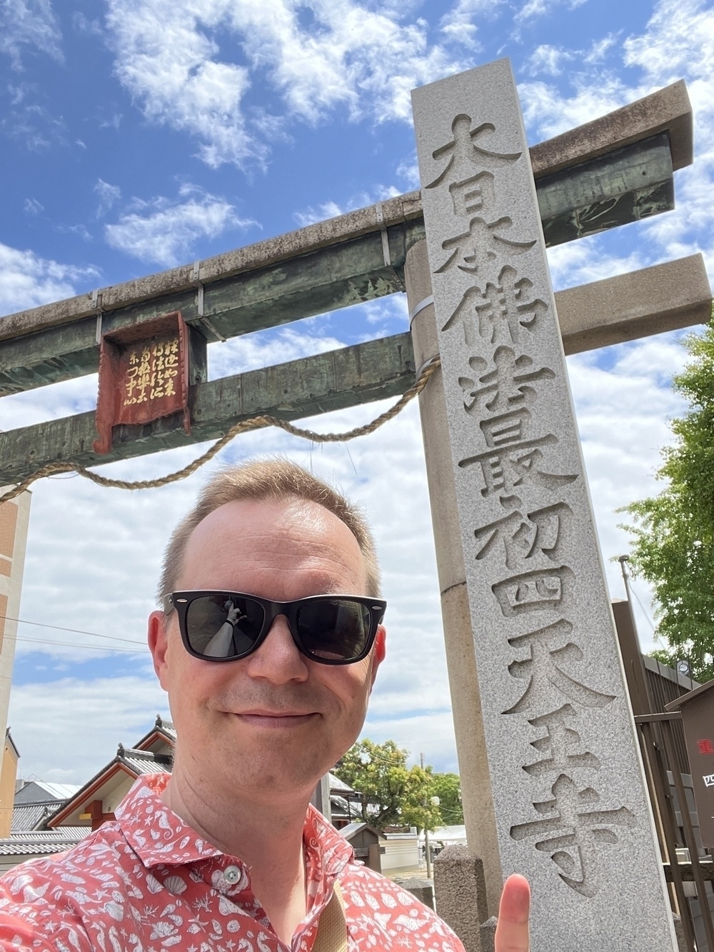 Chad at the gate of Shitenno-ji where the sign claims it is Japan’s first temple