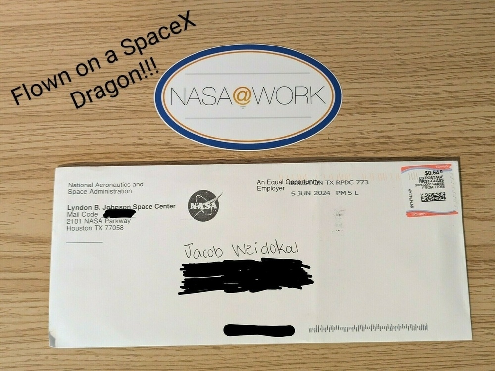 A NASA@WORK sticker that was flown on a SpaceX Dragon, laying above an envelope addressed to Jacob Weidokal from NASA