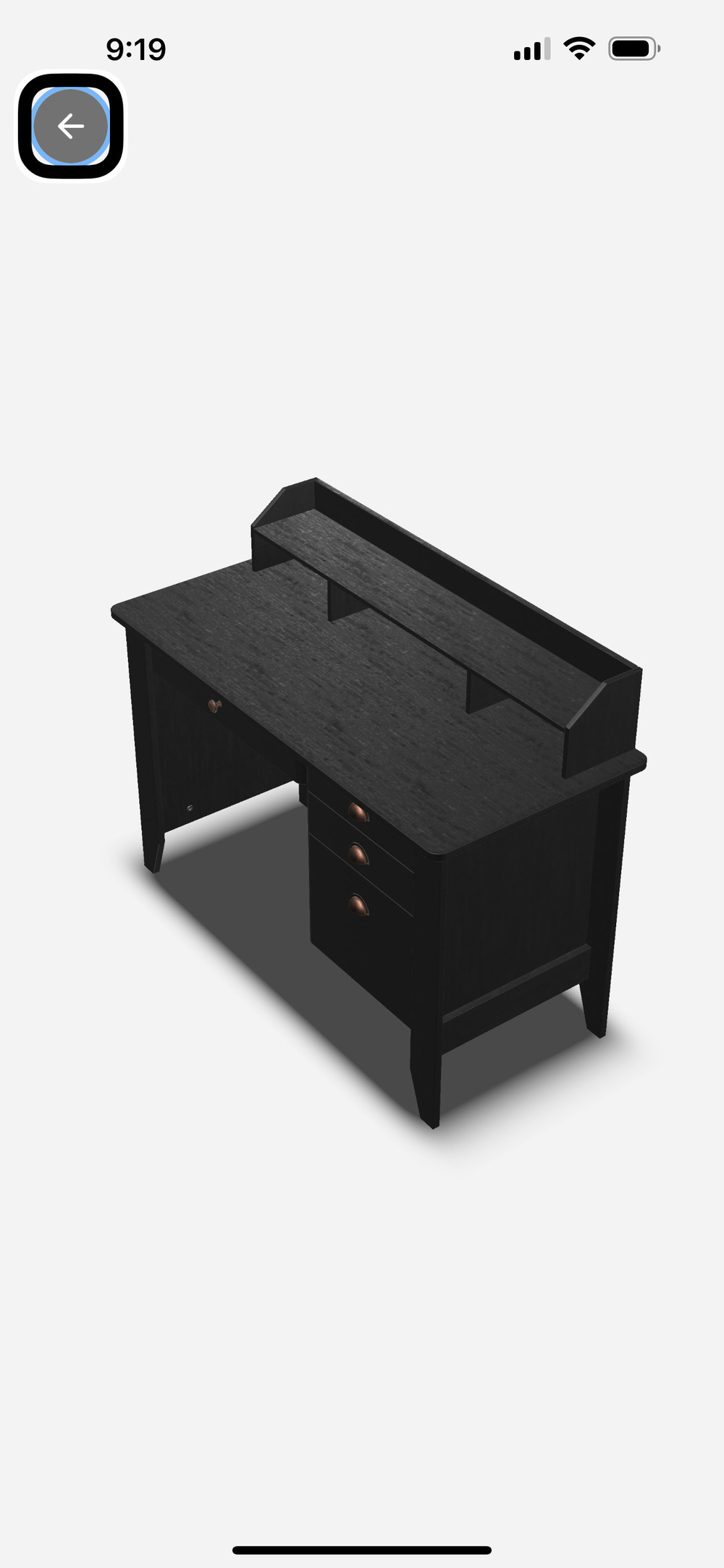 The image shows a black wooden desk with a hutch on top. The desk has a flat surface with a raised back panel that includes two vertical dividers, creating three sections. Below the desk surface, on the right side, there are three drawers with round handles. The desk is positioned against a plain white background.