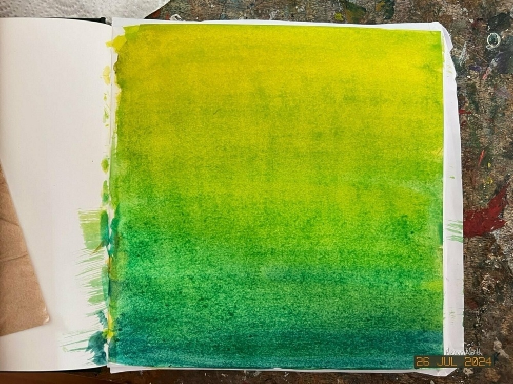 A yellow to green gradient painted top to bottom in a sketchbook 