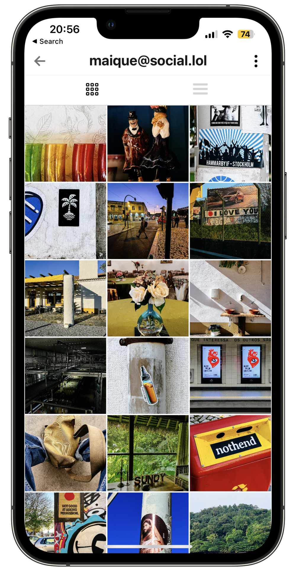 Mock-up of an iPhone with the Pixelfed app showing a feed of photos. 