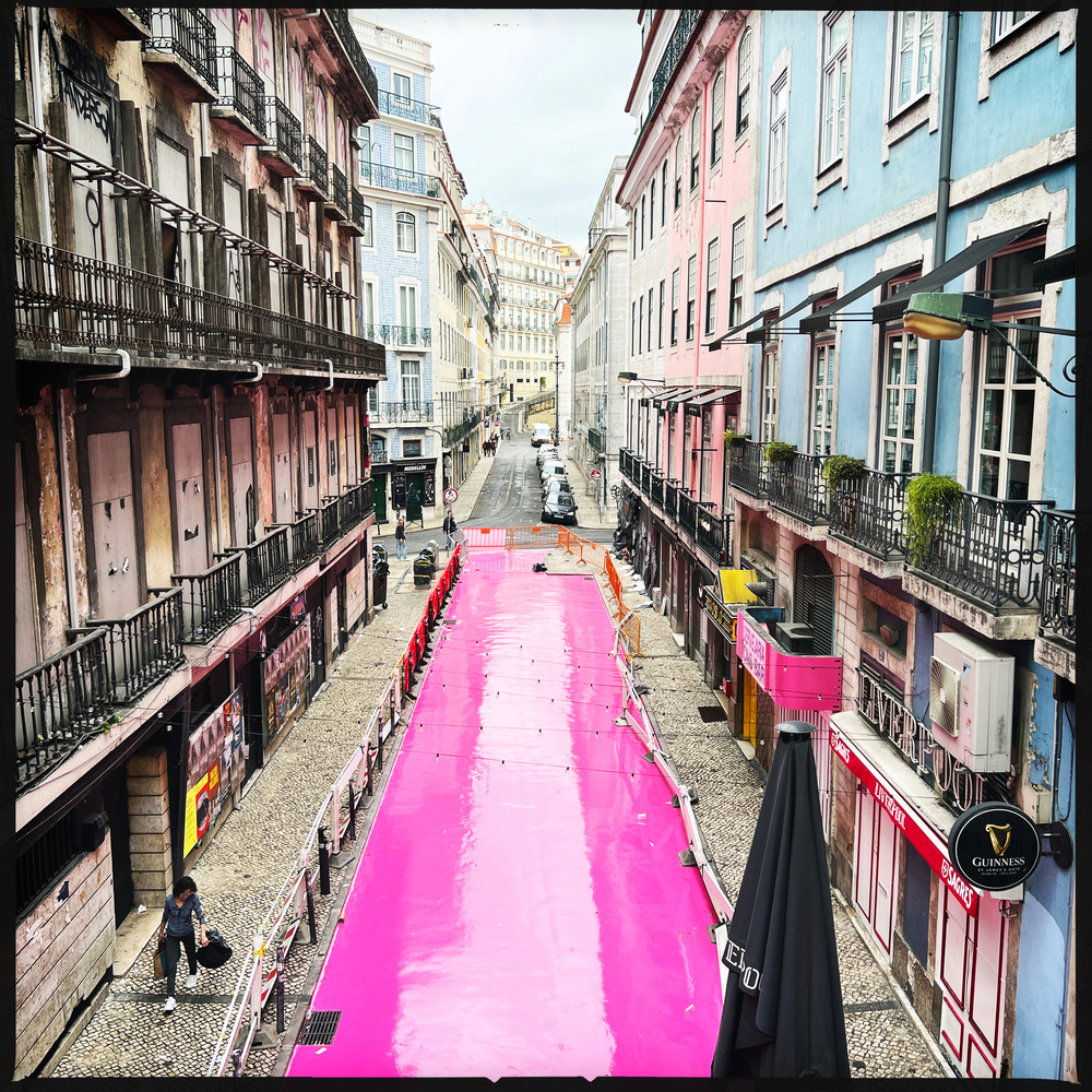 looking down on a street freshly painted in pink