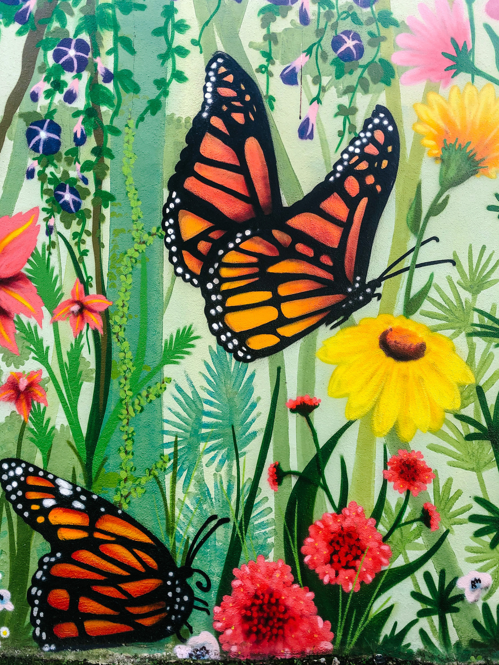 a street art piece, flowers and butterflies