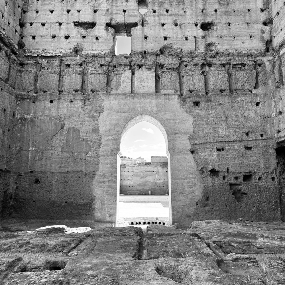 Looking through an arch in a partially ruined palace.