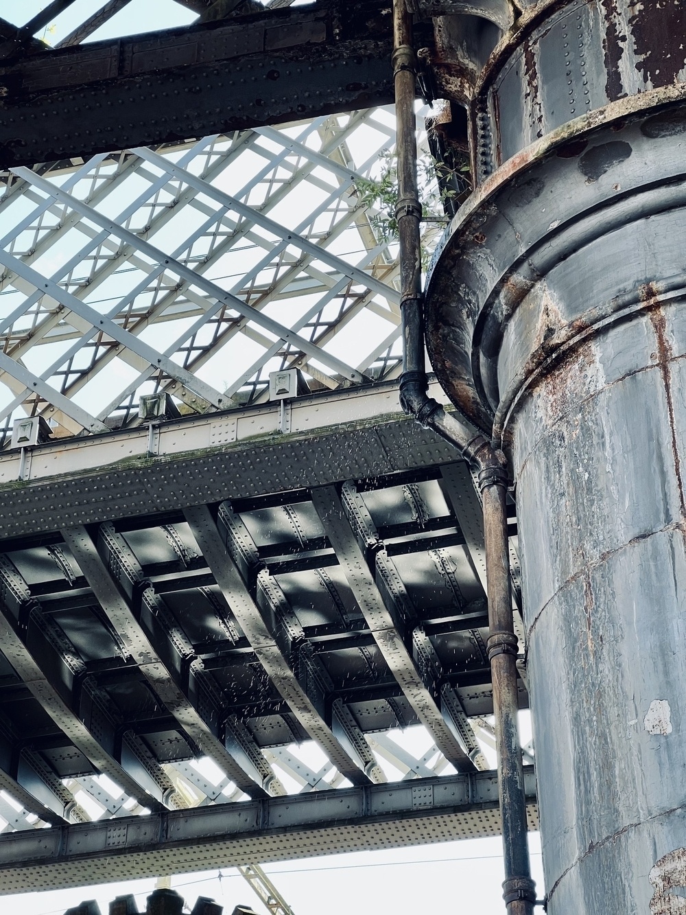 A large grey metal pillar and bridge.