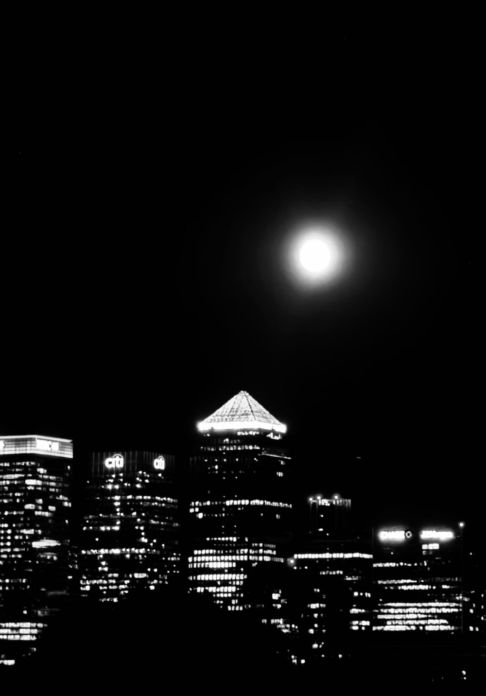 A bright moon over the Canary Wharf skyline.