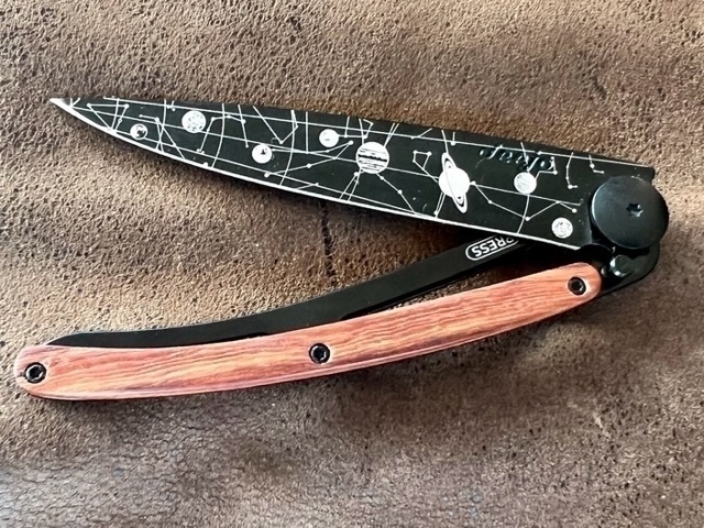 Folding pocket knife with tattooed blade. 