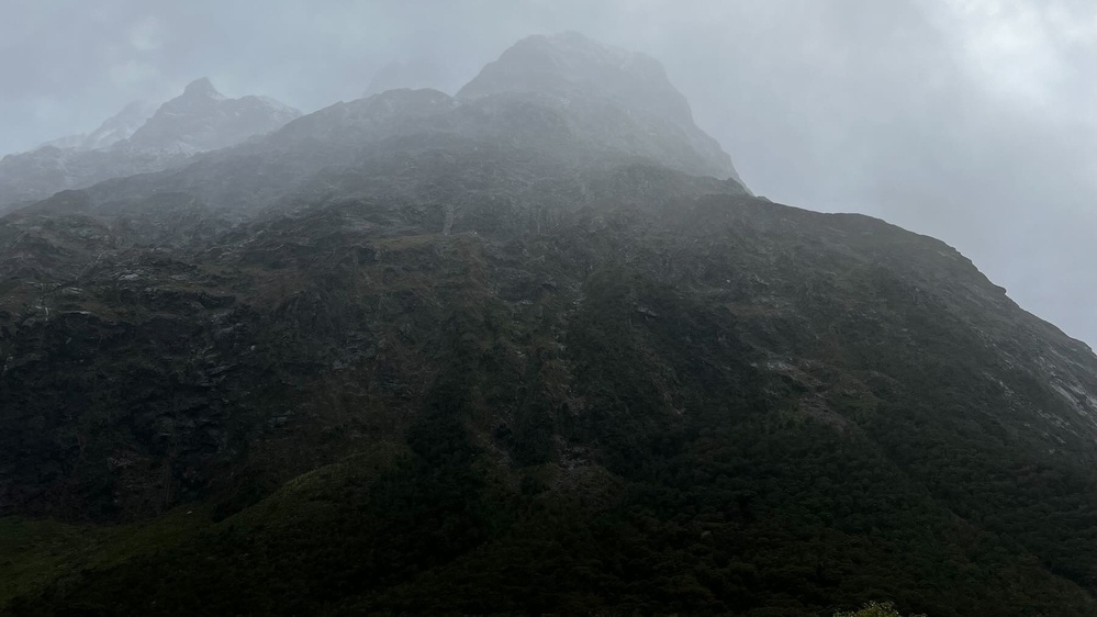 Close-up of a bare mountain shrouded in mist. 