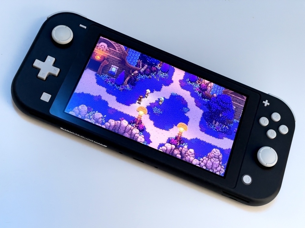 Angled Nintendo Switch on tabletop with Sea of Stars playing on its screen.