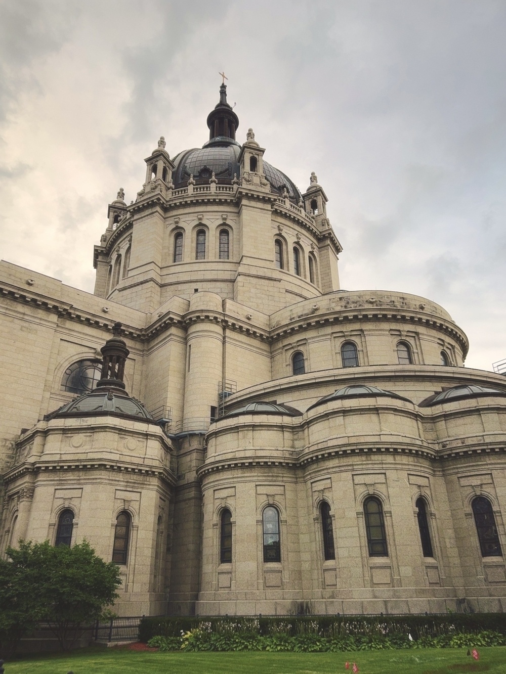 From the ground view looking up a large, multi-room cathedral in beige and dark accents