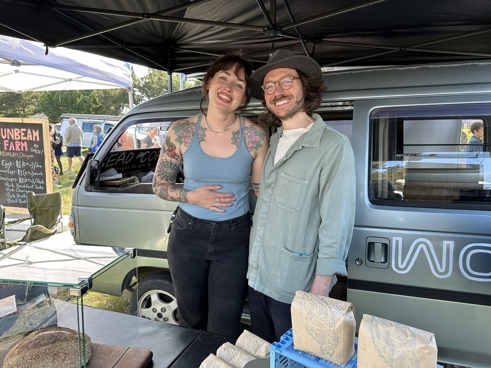 Jordan and Phil, two friendly people with their bread stand at the market