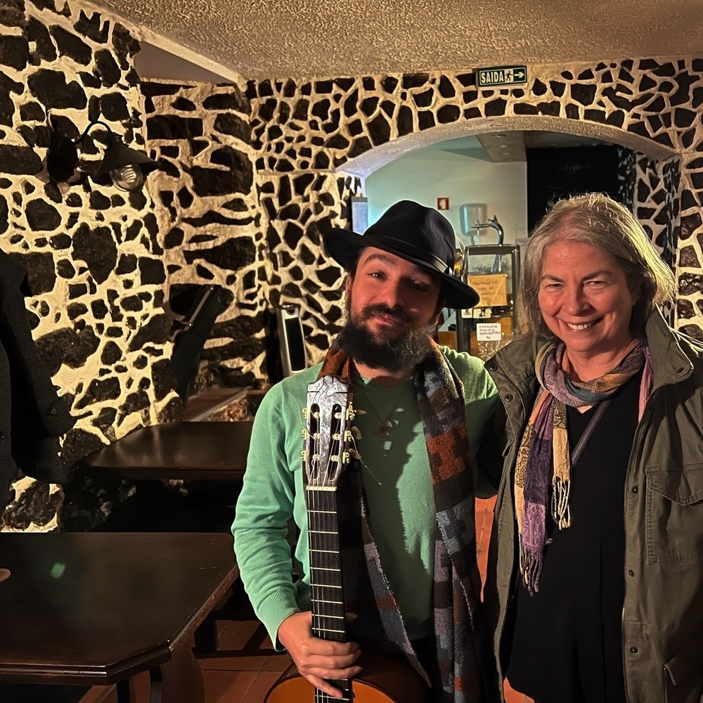 bearded man with hat and guitar with me in the bar after a performance.