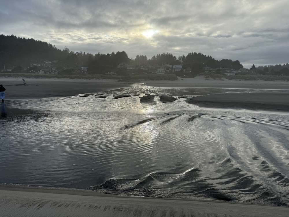 Ocean waves entering a beach creek. 