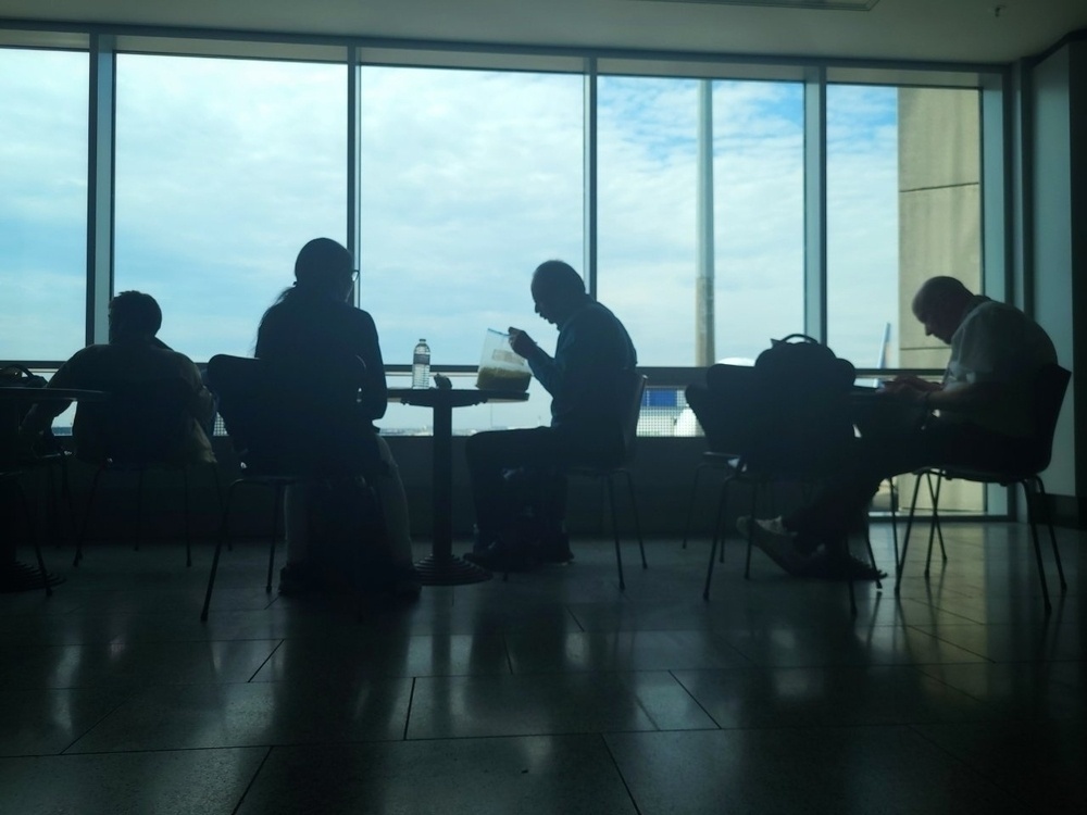 People sitting by airport window