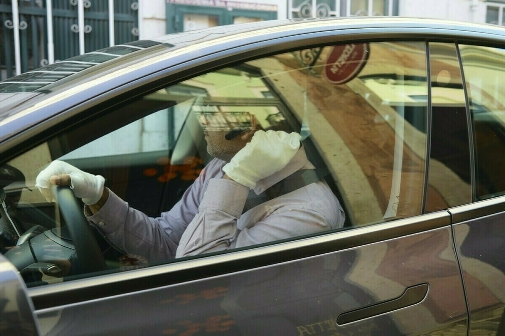 Driver in car with white gloves