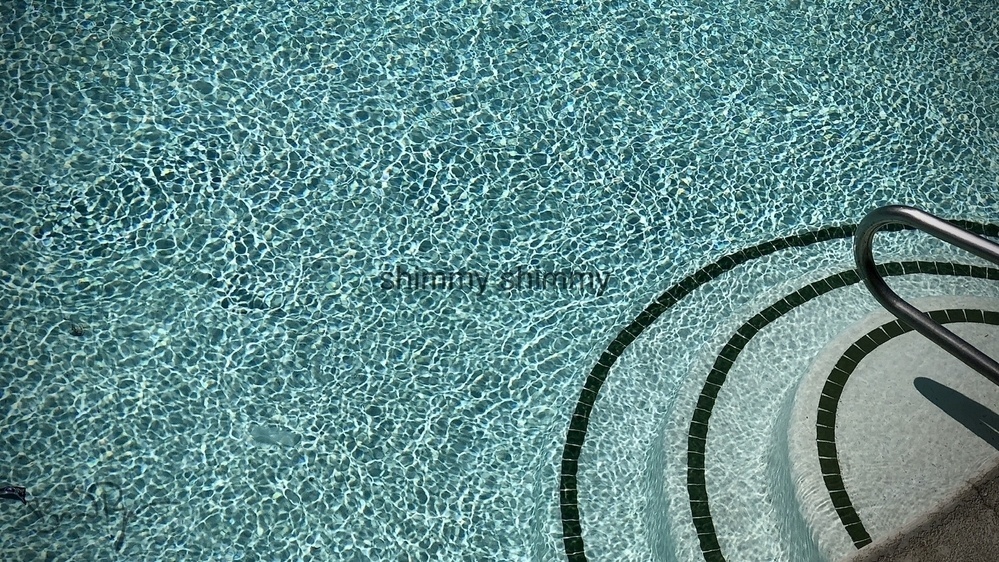 swimming pool shimmering with stairs
