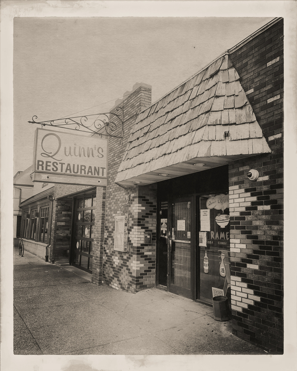 Quinn’s Restaurant sign and storefront. Vintage black and white filter applied.