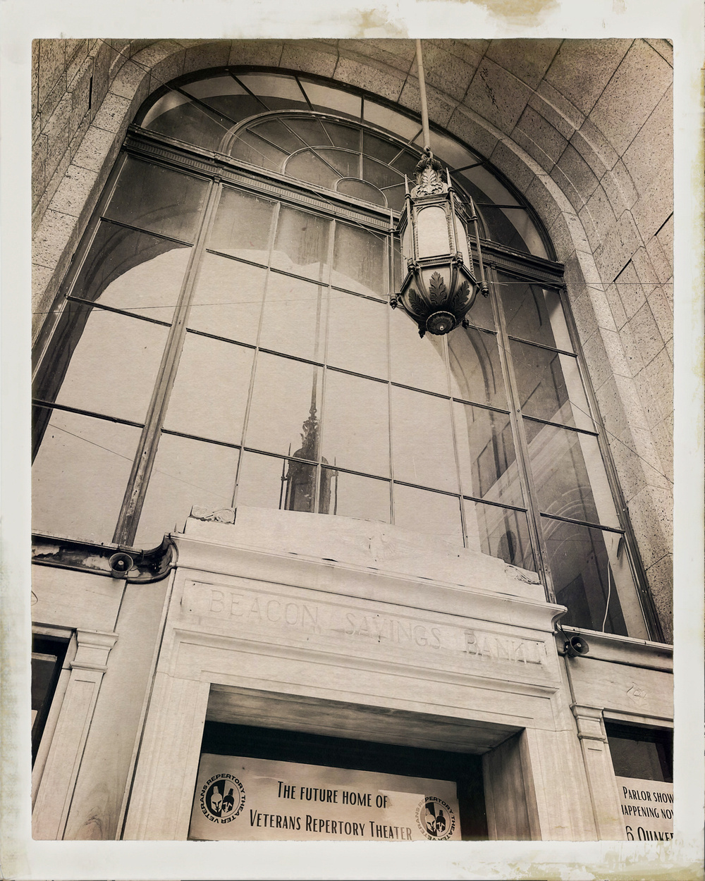 Arched entry to old bank building. Vintage black and white filter applied.