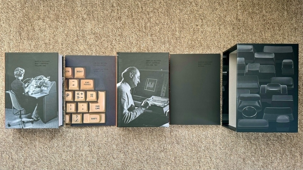 The contents of the "Shift Happens" boxset of two hardback books, one paperback book, and a booklet, laid out side by side.