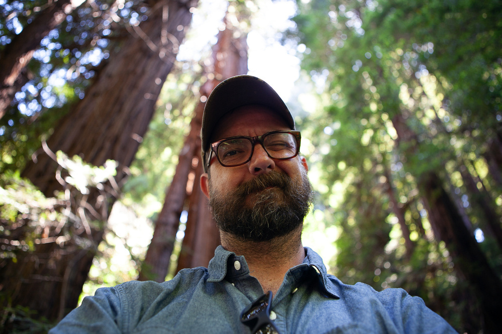 Beared man with glasses takes selfie in old-growth coastal redwood forest - Canon 5D Mark II