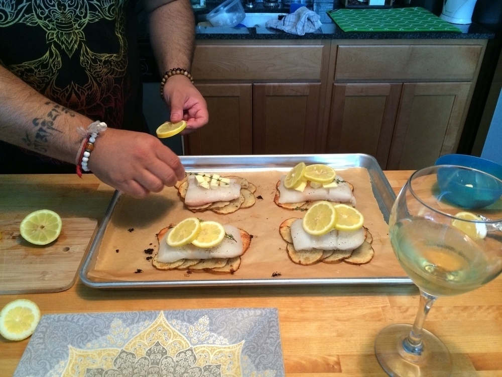 Man adds herbs to fish before baking - iPhone 5S