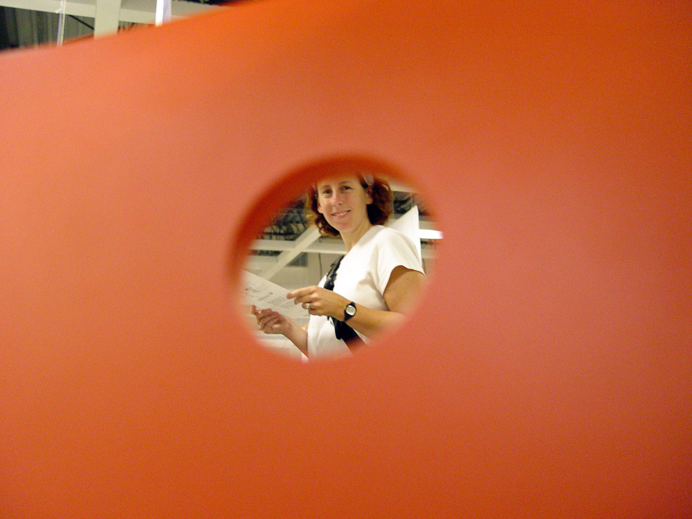 A person shopping at IKEA as seen through the hole in some orange piece of furniture something or other - Sony Cybershot