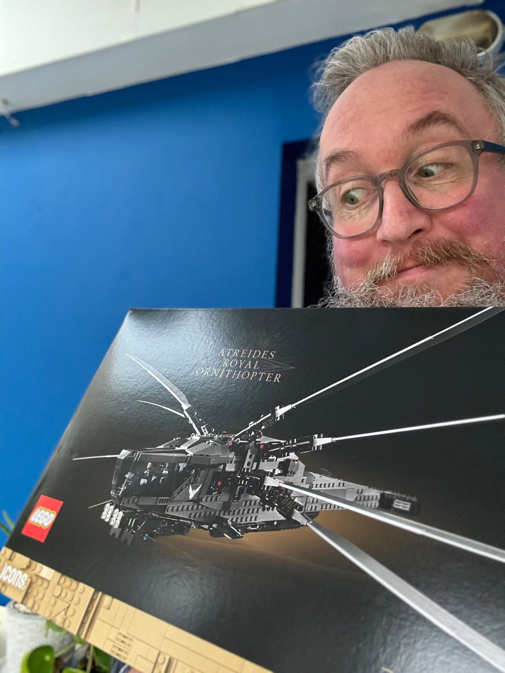 Me holding a LEGO set box featuring the Atreides Royal Ornithopter from the Dune series.