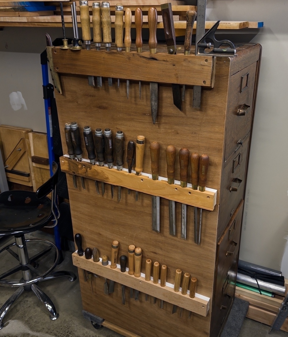 old wooden storage cabinet converted to hold chisels and other tools