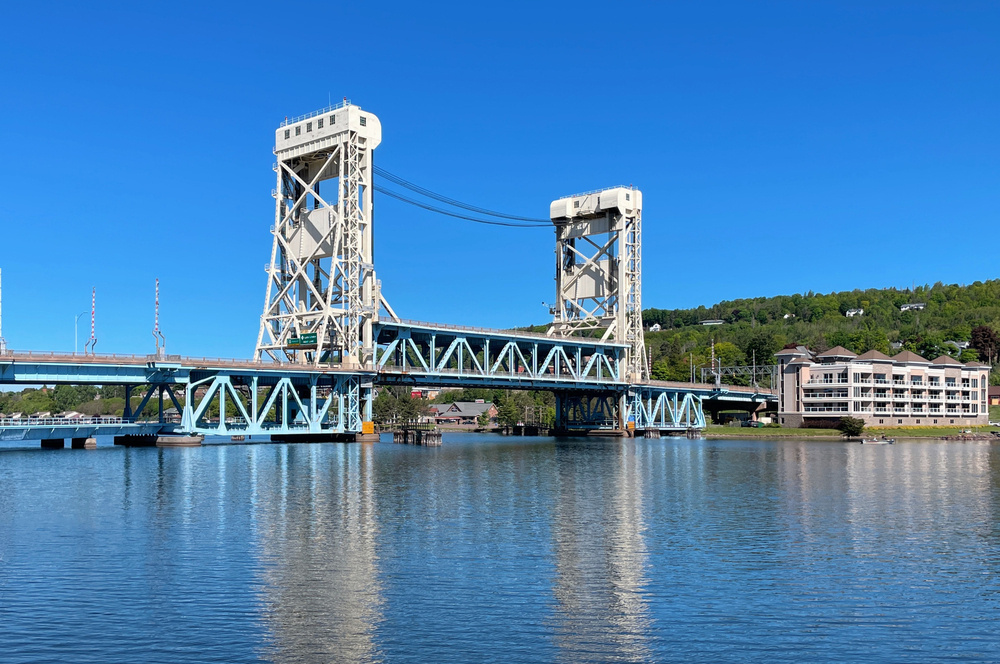 The Houghton vertical lift bridge is double decker truss and painted blue and white. 