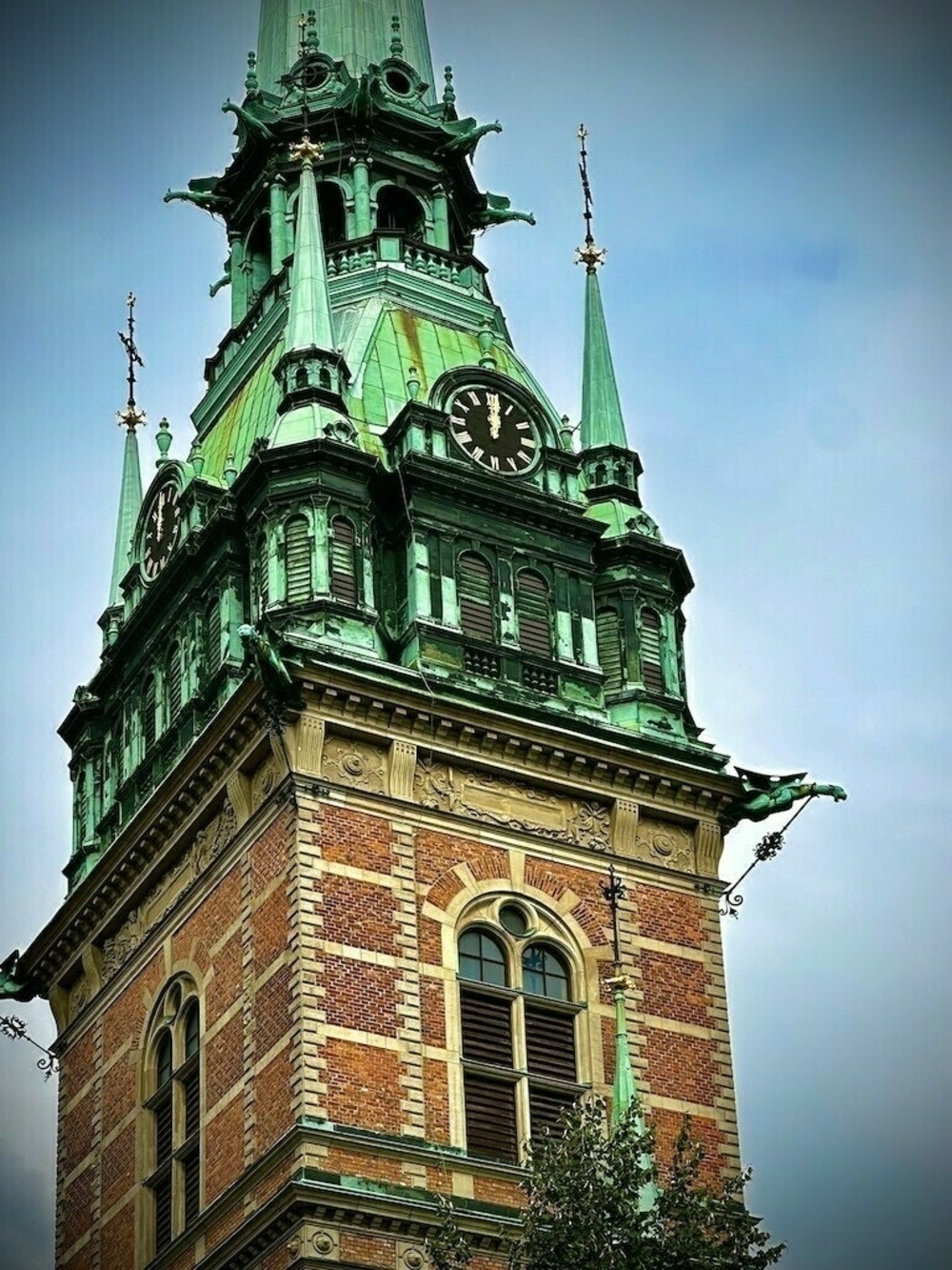 Clock tower in Sweden against blue day sky. 