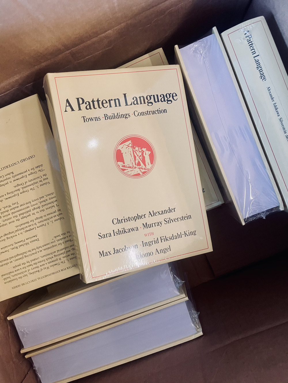 A box full of copies of Christopher Alexander's A Pattern Language.