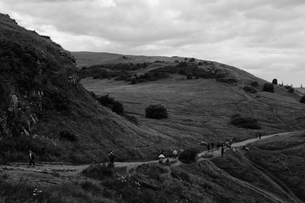 A walking trail cuts across the hills in the landscape. Black and white.