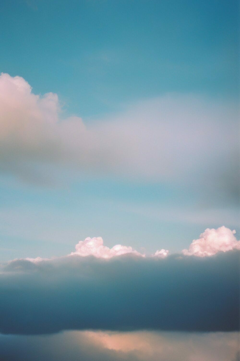 Against a blue-green sky, friendly-looking clouds might build up to something.