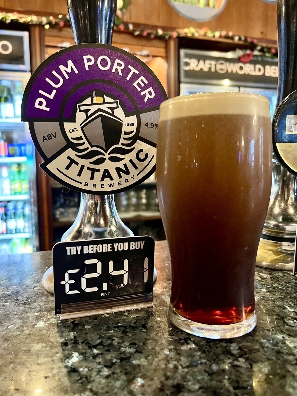 A Pint of Titanic Plum Porter in from of Its Hand Pump. 