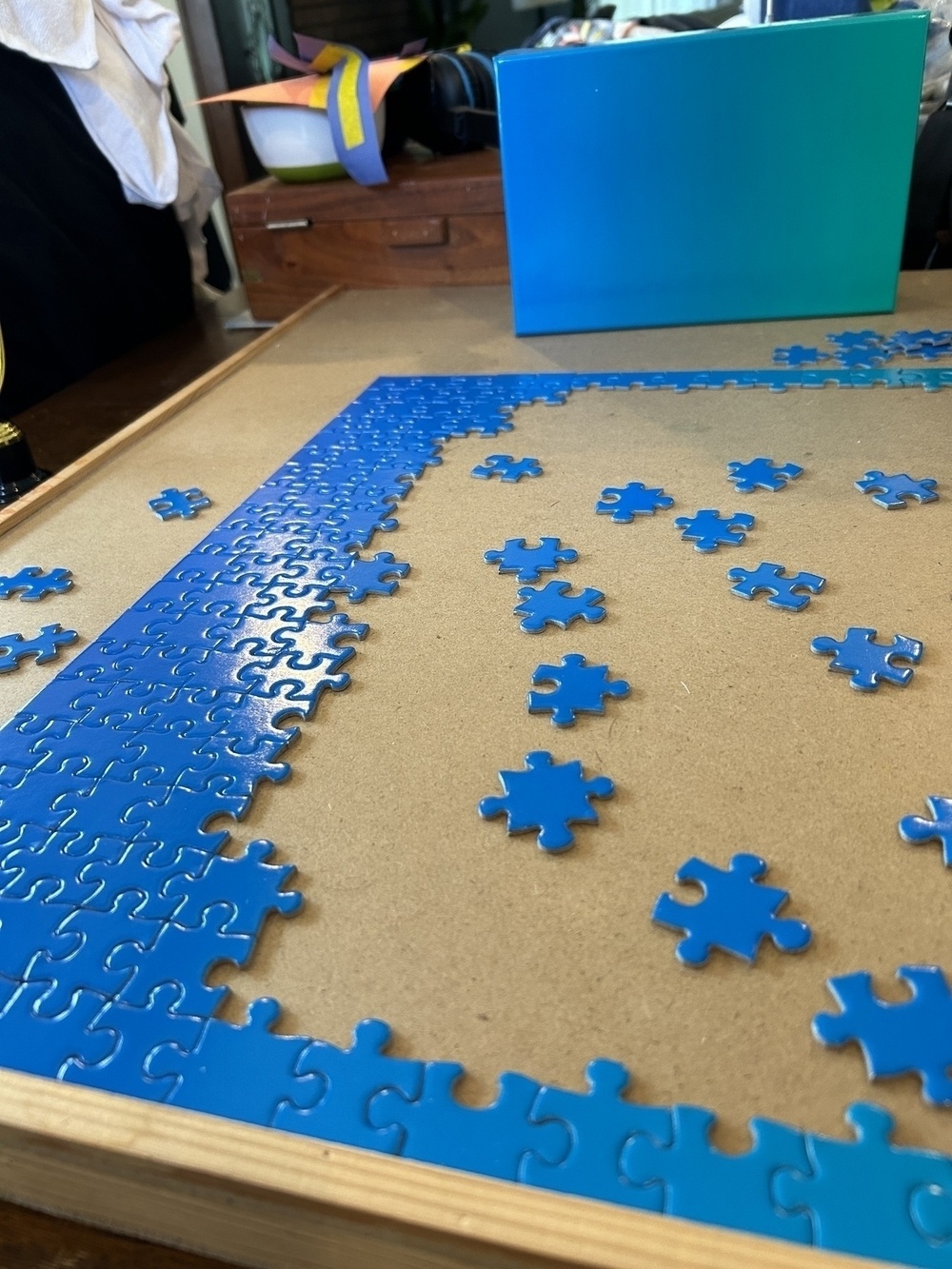 Portion of a blue-to-green gradient jigsaw puzzle in progress. 