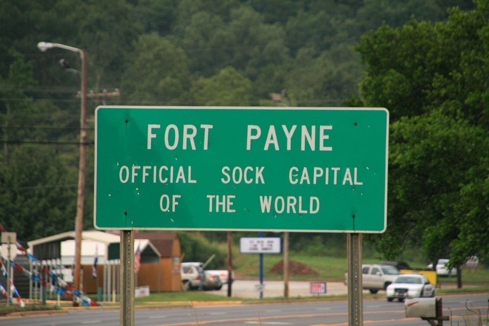 Highway sign that reads Fort Payne: official sock capital of the world