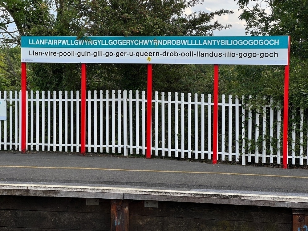 Some ridiculous collection of seemingly random letters on a train station sign in Wales.