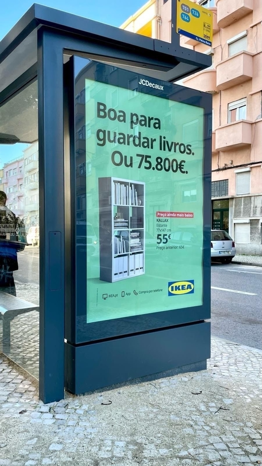 Outdoor advertisement for IKEA written in Portuguese. The outdoor advertised the KALLAX bookshelf, now at an even lower price. In large bold letters, the advert reads “Good to store books. Or €75,800.” 