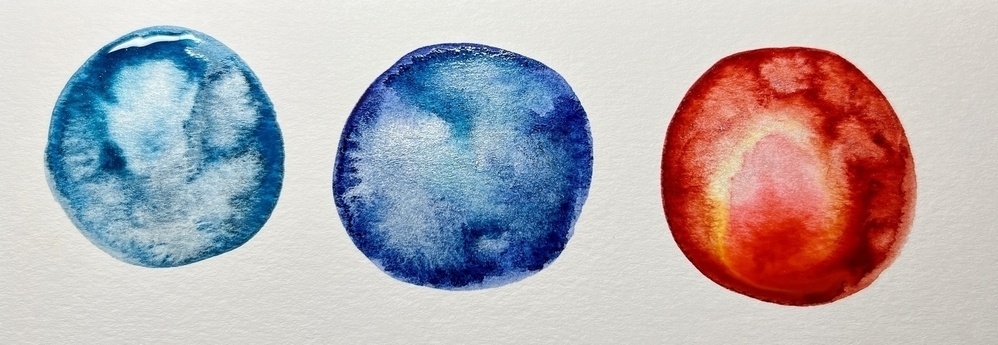 Three circles filled with watercolor, the first in cerulean, the second in Prussian blue, the third in deep scarlet. All three have silver sparkles mixed in. 