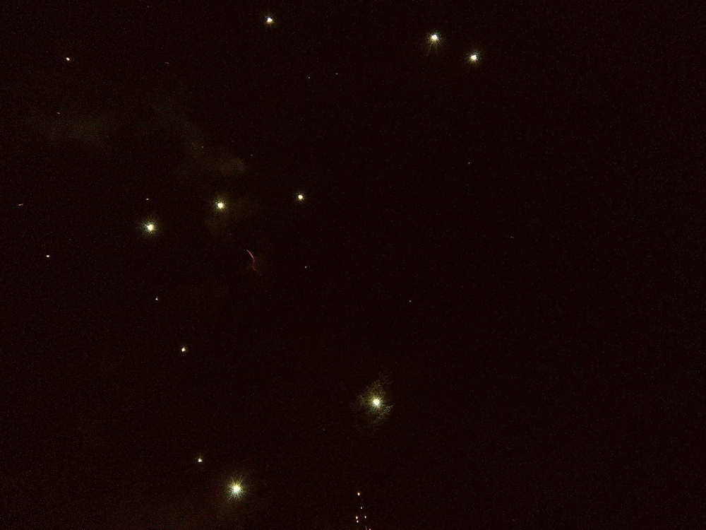  fireworks looking like faraway galaxies in a black sky