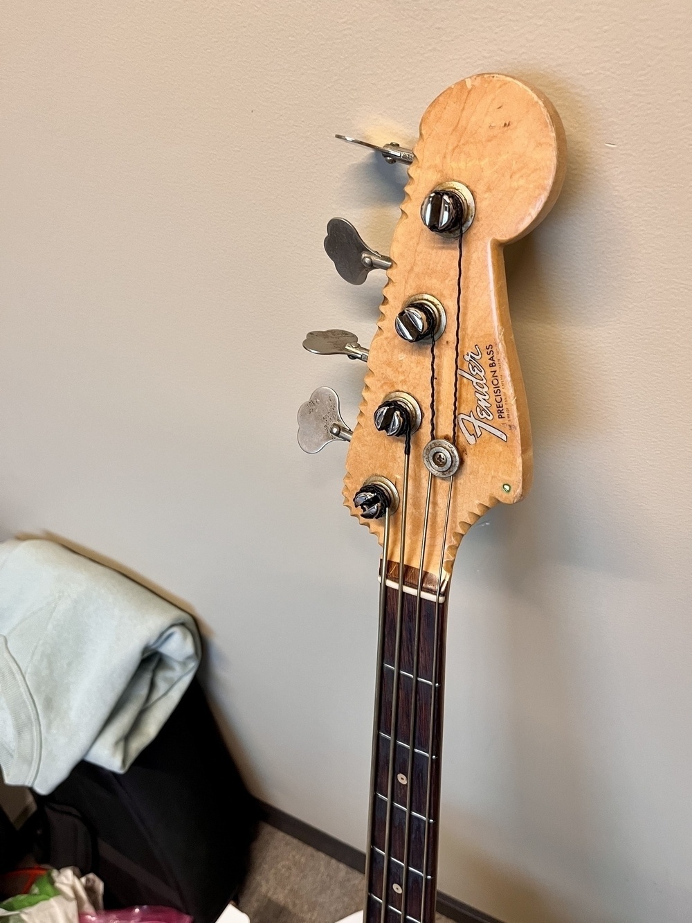 The headstock, also with a bunch of notches. The clay inlays has small holes with lime green paint, for some reason!