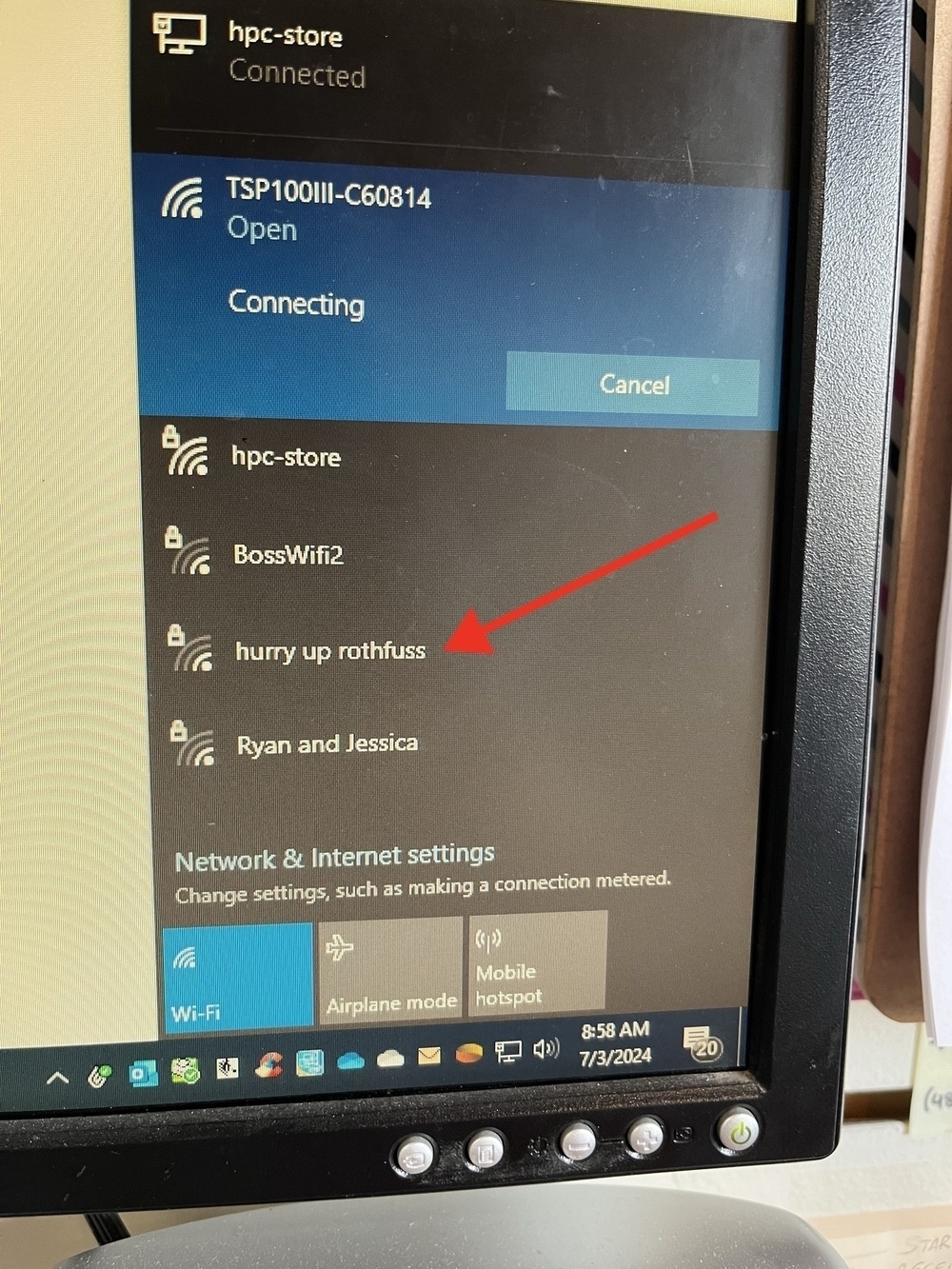 A computer screen showing a list of Wi-Fi networks, one named &ldquo;hurry up rothfuss&rdquo; is highlighted with a red arrow. It&rsquo;s 8:58 AM on 7/3/2024.