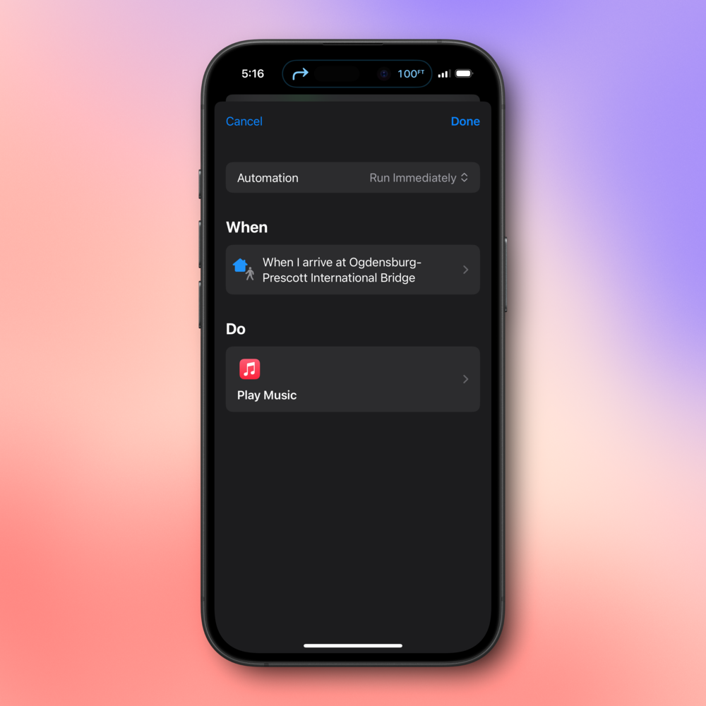 A smartphone screen displays an automation setup with tasks: &ldquo;When I arrive at Ogdensburg-Prescott International Bridge,&rdquo; then &ldquo;Play Music.&rdquo; The background is a gradient of soft pink and purple.