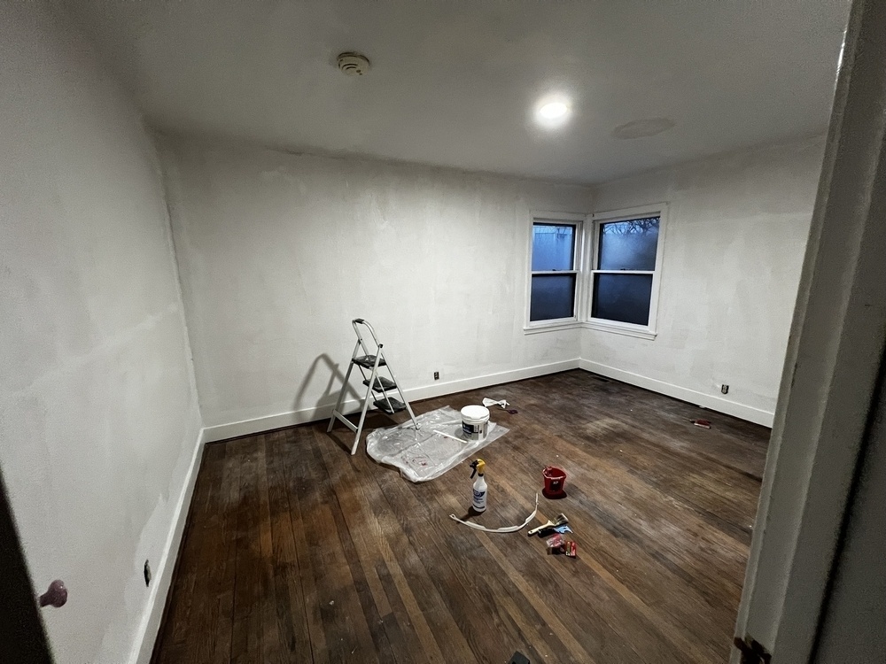 An empty room, in the midst of being prepared for painting.